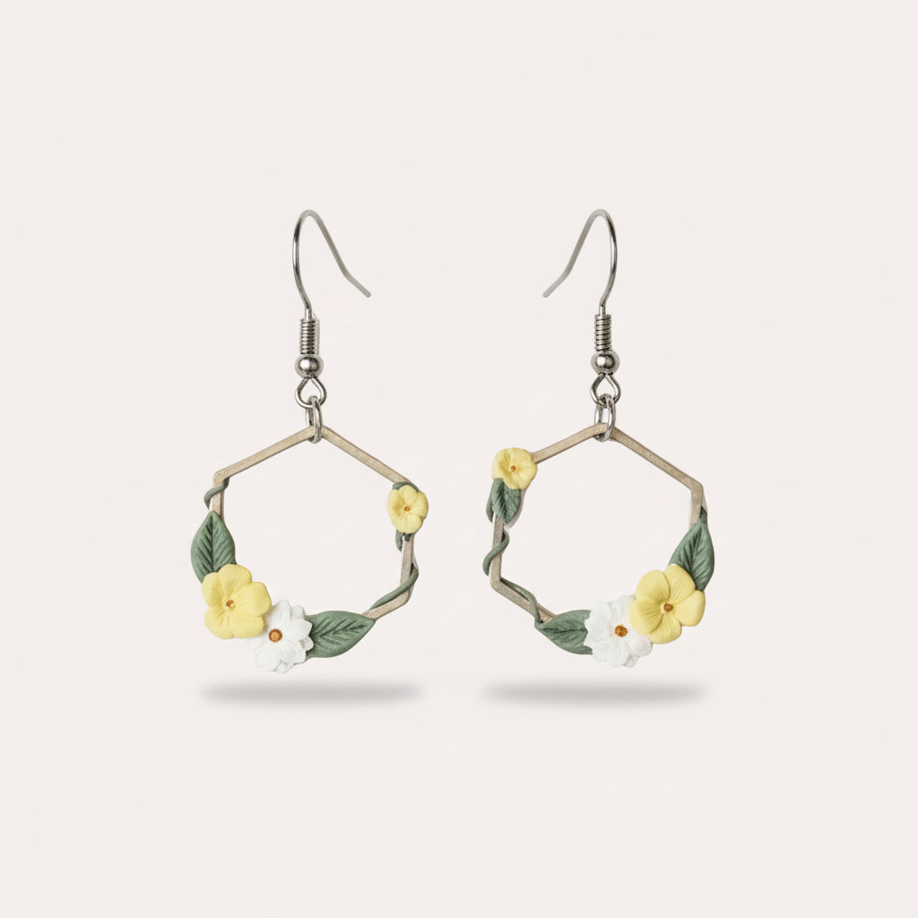 silver hexagon shaped earrings with yellow and white flowers