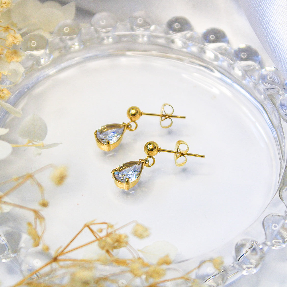 Clear crystal teardrop shaped earrings on gold plated stainless steel stud earrings for sensitive ears