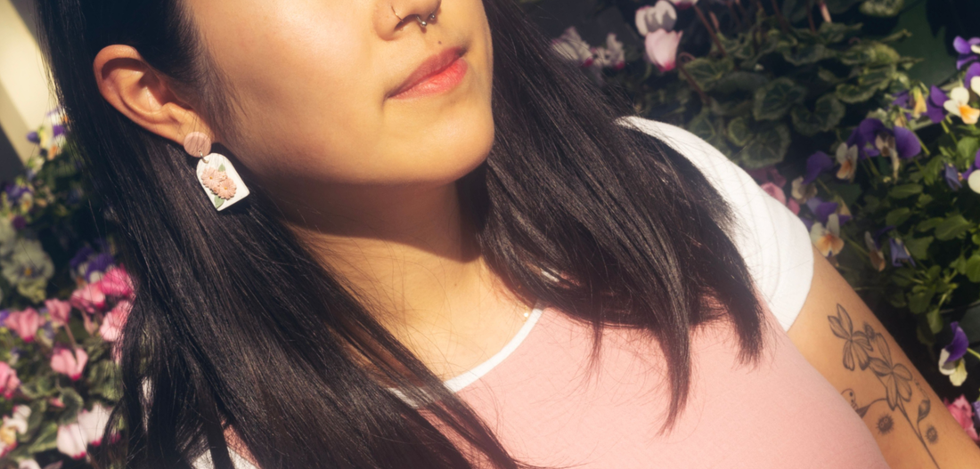 girl wearing floral stainless steel earrings in Auckland garden