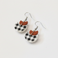Pair of earrings with checkered design on a white background