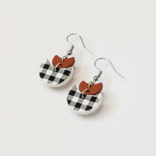 Pair of earrings with checkered design on a white background