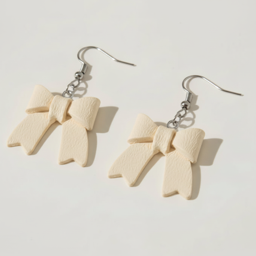 Pair of bow-shaped earrings on a light background