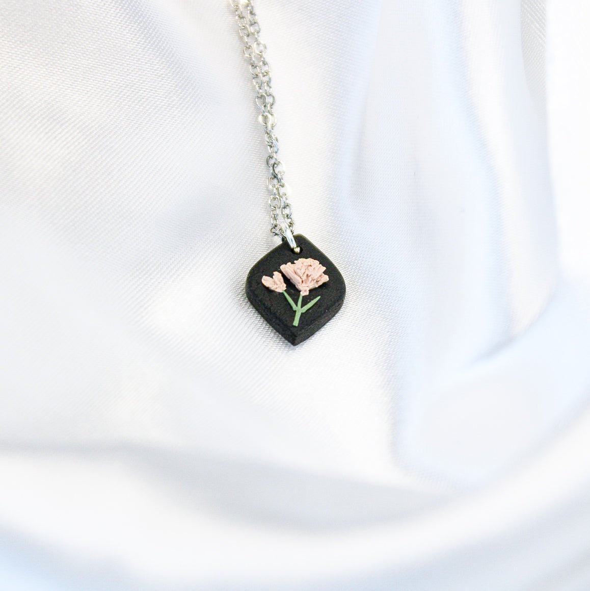 Silver raven carnation birth flower necklace — January pendant