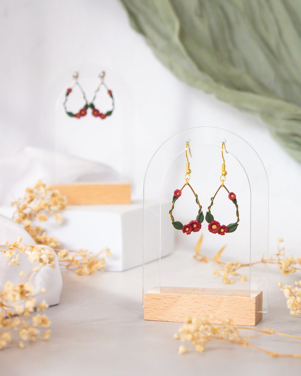 Close-up of cherry red polymer clay ivy on gold droplet frame | handpainted earrings NZ