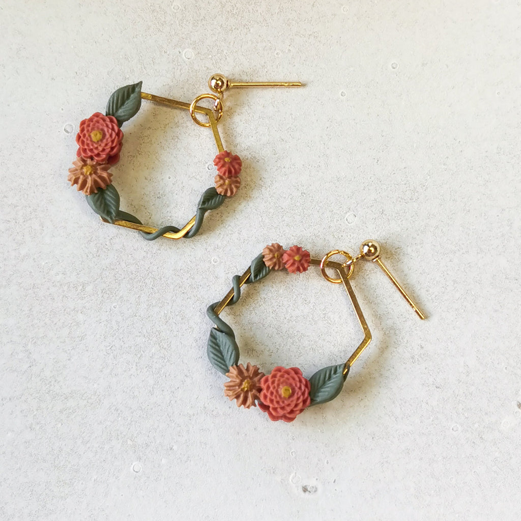 Close-up of handpainted flowers in gold hexagon frame | hypoallergenic earrings New Zealand